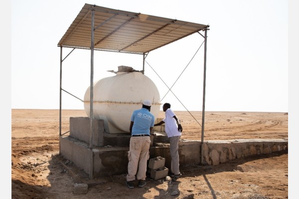 Water tanks in the Djibouti deserts provide lifesaving relief for migrants traversing the route. Pictured is the IOM Medical Doctor checking the level of the water, to ensure there is enough and as an indication of whether migrants have passed, during Mobile Patrol Unit in the Desert near Obock. Photo: Eva Sibanda IOM 2023.