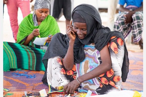 A female migrant engages in a tapestry activity as part of MHPSS activities offered to migrants at the centre in Obock, Djibouti. Photo: Eva Sibanda/IOM 2023.